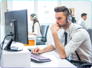 pensive-business-man-with-headset-workplace-office-front-computer